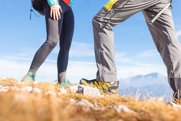 Moosehill HikerFlex series durable hiking pants vs. lightweight leggings for men and women on a forest trail